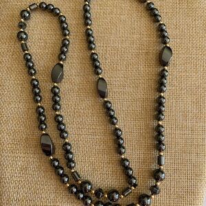 Long hematite necklace with gold accents. Protection and grounding stone.